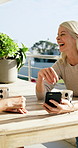 Phone, friends and women laugh at balcony for social media, conversation or funny story with smile. Mobile, joke and mature people at house together to talk, share comedy and show post with surprise