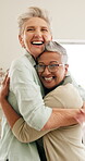 Mature, women and excited for hug in house for visit, bonding and connection in living room. Friends, people or happy with embrace, care and love with conversation of gratitude for relationship