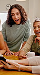 Phone, surprise and mature friends in house for social media, conversation or online gossip with drink. Mobile, women and together at apartment with shock, wow or share rumor on internet with coffee