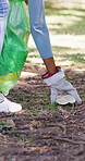 Volunteer, hand and trash bag in park with garbage collection, charity project and waste management. Person, cleaning outdoor and plastic for rubbish, sustainability and eco friendly NGO initiative.