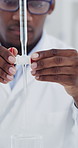 Scientist, innovation and man with stopcock in lab, biochemistry or analysis for vaccine development. Clinic, equipment and black person with chemical, medical research and experiment for cancer cure