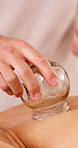 People, hands and cupping therapy with masseuse for spa, body treatment or vacation in salon. Woman, relax and glass for holistic healing, zen or beauty session for inflammation or circulation