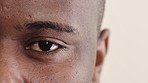 Blink, eye and vision with black man in studio for optometry appointment or checkup. Healthcare, optical and eyesight with patient at ophthalmology assessment for visual correction or improvement