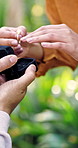 Couple, hands and ring box for proposal, engagement and connection with partner at park. Marriage question, man and woman with jewelry outdoor for love, relationship commitment or romance with fiance