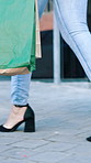 Legs, shopping bags and walking with people on sidewalk for commercial or retail sale. Fashion, feet and high heels with woman friends outdoor in city for buying, consumerism or spending spree