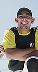 Face, man and baseball player with confidence at sports park, fitness and arms crossed for pride. Portrait, pitcher and professional athlete with ball outdoor, smile and ready for game training
