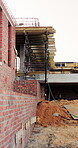 Construction, remodel or building site with scaffolding, vacant area or improvement of structure. Industrial, empty or demolition with project progress, refurbishment or maintenance of infrastructure
