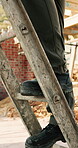 Legs, worker and climb on ladder in construction for scaffolding, roof access or site inspection. Safety boots, person or labor outdoor for structural framework, industrial development or maintenance