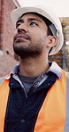 Architect, man and thinking at construction site with inspection, project and property development. Low angle, person and quality assurance outdoor with building renovation, planning or architecture.