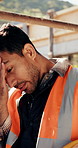 Construction, worker and headache with helmet outdoor, overwhelmed or overworked at building site. Engineer, employee or man with hardhat, migraine or pain with pressure, tension and exhausted