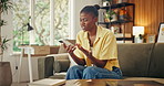 Frustrated, woman and surprise in home with phone, unexpected news and text message for online gossip. Black person, shock and doubt in couch with tech, mobile chat and typing for social media rumor.