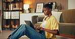 Laptop, typing and black woman in house with remote work, research or complete copywriting for campaign. Creative, person and freelance copywriter in lounge with computer, browsing or finish project.