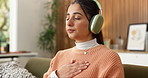 Meditation, breathing and woman with music in living room for peace, calm and wellness podcast. Breathwork, headphones and person on sofa at home for mindfulness audio, relax and zen for self care