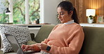 Laptop, sofa and woman with credit card, online shopping and purchase on website store in home. Happy, typing and person on computer for digital banking, virtual payment and transaction for ecommerce