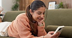 Woman, laugh and texting with phone in lounge, online and communication with contact on social media. Happy person, browsing and chatting with mobile, networking and reading funny message in house