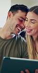 Tablet, conversation and couple in home with planning anniversary holiday together with booking tickets. Happy, talking and man with woman on technology for research on hotel checkin in apartment.