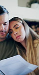 Couple, debt paperwork and hug in home with stress, comfort and discussion of mortgage and bills. Anxiety, document and people with banking, finance and accounting issue for loan in living room