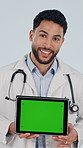 Face, tablet and doctor with green screen, healthcare and insurance marketing in studio. Tech display, happy man and medical worker with mockup space, laugh or telehealth ads on white background