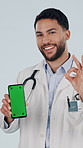 Face, phone and doctor with green screen, okay sign and  marketing for healthcare insurance in studio. Medical, happy man and mobile with space, perfect gesture or telehealth ads on white background