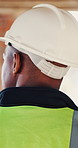 Walking, thinking and back of man for construction site, quality assurance and building project. Architecture, contractor and worker with planning for engineering, safety compliance and inspection