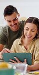 Couple, cooking and smile with tablet in kitchen, online or learning culinary skills on social media. Meal prep, home and happy people with tech, discussion and recipe tips on website and research