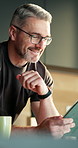 Man, typing and remote work in home with tablet, email notification or good news for creative project. Happy, mature person or freelancer in house with tech, reading business communication or website