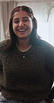 Laughing, relax and face of woman in home for confidence, peace and stress relief on weekend break. Happy, wellness and funny joke with female person in apartment for pride, calm and self care