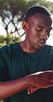 Runner, breathing and smart watch with black man in nature for tracking heart rate, fitness and break. Health stats, exercise recovery and tired with person outdoor for fatigue and endurance training