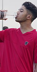 Drinking, water and man on soccer field, wellness and hydration after practice and match preparation. Outdoor, athlete and person with mineral on break, thirsty and cool down with liquid or fitness