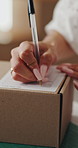 Hands, box and writing on shipping label for package delivery, tracking code and logistics process. Small business owner, woman and parcel sticker for distribution notes, address info or supply chain