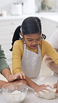Family, child and baking at house with dough, learning and culinary skills for homemade cookies. Mother, grandmother or teaching kid in home with pastry, kneading technique and supervision for treats