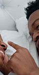 Playful, touch and black couple in bedroom for morning, bonding and relax together on weekend. Marriage, happy and man with woman in bed for connection, relationship and affection for love in home