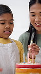 Baking, candles and mom with child with cake, dessert and sweet treats for celebration in home. Family, happy and mother with girl for birthday, bonding and help for decoration, learning and love