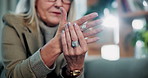 Hands, arthritis and senior woman in home with injury, relief and massage for carpal tunnel syndrome. Elderly person, finger discomfort or health issue with orthopedic disease, ache and chronic pain.