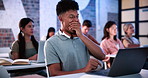 Man, laptop and tired in classroom with yawn at university with notes, review and development with education. Person, pc and students with burnout for learning, scholarship and fatigue at college