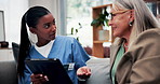 Nurse, tablet or old woman with discussion on couch, explain results or advice for medical report. Tech, caregiver or senior person with instructions for health care, wellness update or smile in home
