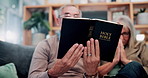 Old couple, hands and reading bible in home for religion study, bonding or faith for Christianity. Senior people, prayer and holy book for scripture, gospel or spiritual relationship in retirement