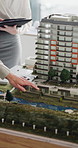Meeting, hands or real estate with 3D model for building development or planning renovation in office. People, team or realtor group with structure or prototype for urban construction or architecture
