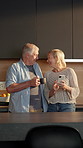 Laugh, coffee and couple with phone in kitchen for internet meme, funny online video and bonding. Tea, mature people and happy with mobile in home for reading comic status, healthy marriage and joke