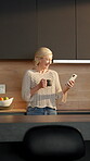 Coffee, woman and laugh with phone in kitchen for internet meme, funny online video and streaming. Beverage, mature person and happy with mobile in home for reading comic status, social media or joke