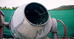 Empty, site and concrete mixer for construction, ingredients and combine cement for architecture. Machine, mortar or mixing process outdoor for foundation, building materials and urban infrastructure