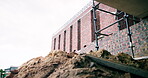 Building, empty or rubble on construction site with scaffolding, urban development or renovation. Low angle, space or infrastructure on worksite for revamping project, engineering design or brickwork