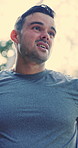 Tired, man and fitness with sweat in nature for outdoor run, workout or intense exercise. Exhausted, male person or runner with breathing break, rest or recovery for training challenge in forest