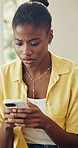 Phone, confused and black woman in home for texting, communication or social media on mobile app. Upset, typing and African female person with cellphone for chatting, networking or email in house.