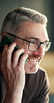 Phone call, funny and mature man in home for conversation, news update or laugh at story on weekend. Mobile, contact and happy person at apartment with joke, communication or talking for connection