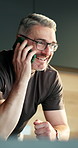 Phone call, laugh and mature man in home for conversation, funny story or news update on weekend. Mobile, contact and happy person at apartment with joke, communication or talking for connection