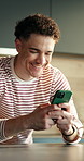 Texting, home and happy man with phone for online communication, network or social media. Male person, user or smile with smartphone for mobile chat, conversation or virtual discussion in house
