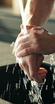 Washing hands, person and kitchen tap for hygiene, wellness and health with clean skin in home. Closeup and cleaning bacteria or germs with disinfection, splash and rinse with soap and maintenance