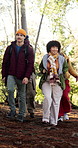 Walking, friends and travel with hike in forest for thinking, explore and adventure on holiday or view. Outdoor, hiker and people for sightseeing on vacation, backpacking or wellness in nature