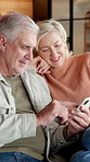 Mature, couple and laugh for phone on home sofa for online browsing, social media and internet. Happy man, woman and joke with technology or talking, mobile app and streaming on living room couch